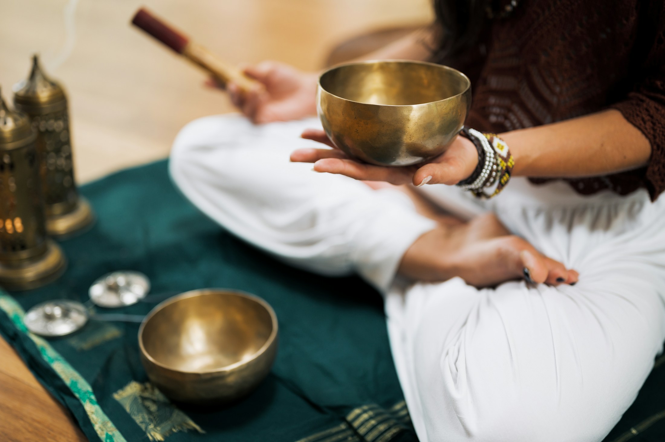 A singing bowl held with a wooden striker during sound practice
